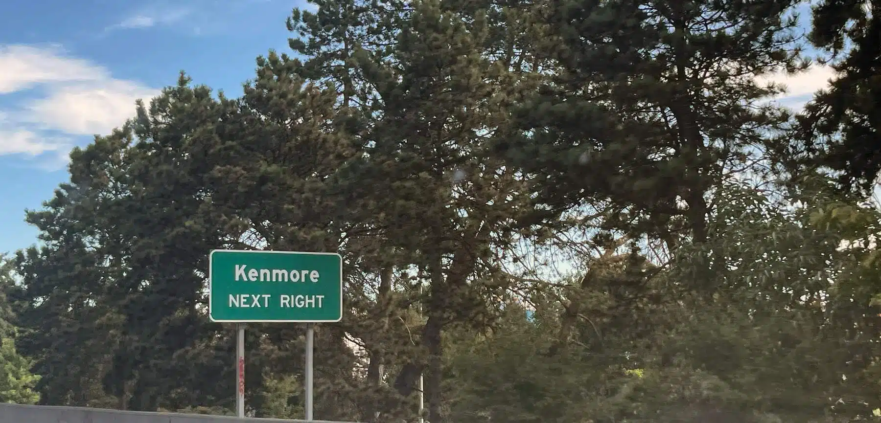 Kenmore road sign saying next left.