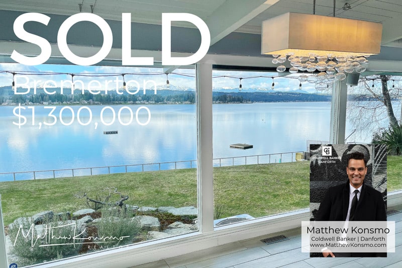 Sold marketing graphic for a Bremerton, WA waterfront home with floor-to-ceiling windows framing panoramic Puget Sound and mountain views — closed at $1,300,000 by Matthew Konsmo, Coldwell Banker Danforth.