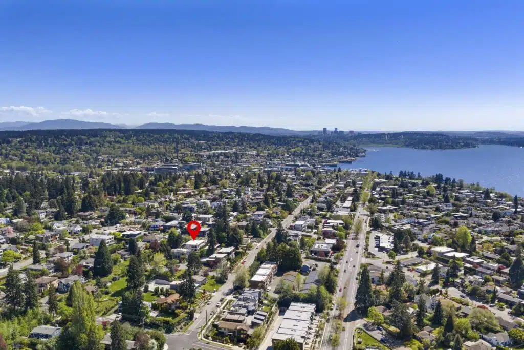 Sweeping aerial view showcasing the home's coveted East of Market location with Lake Washington and downtown skyline beyond.