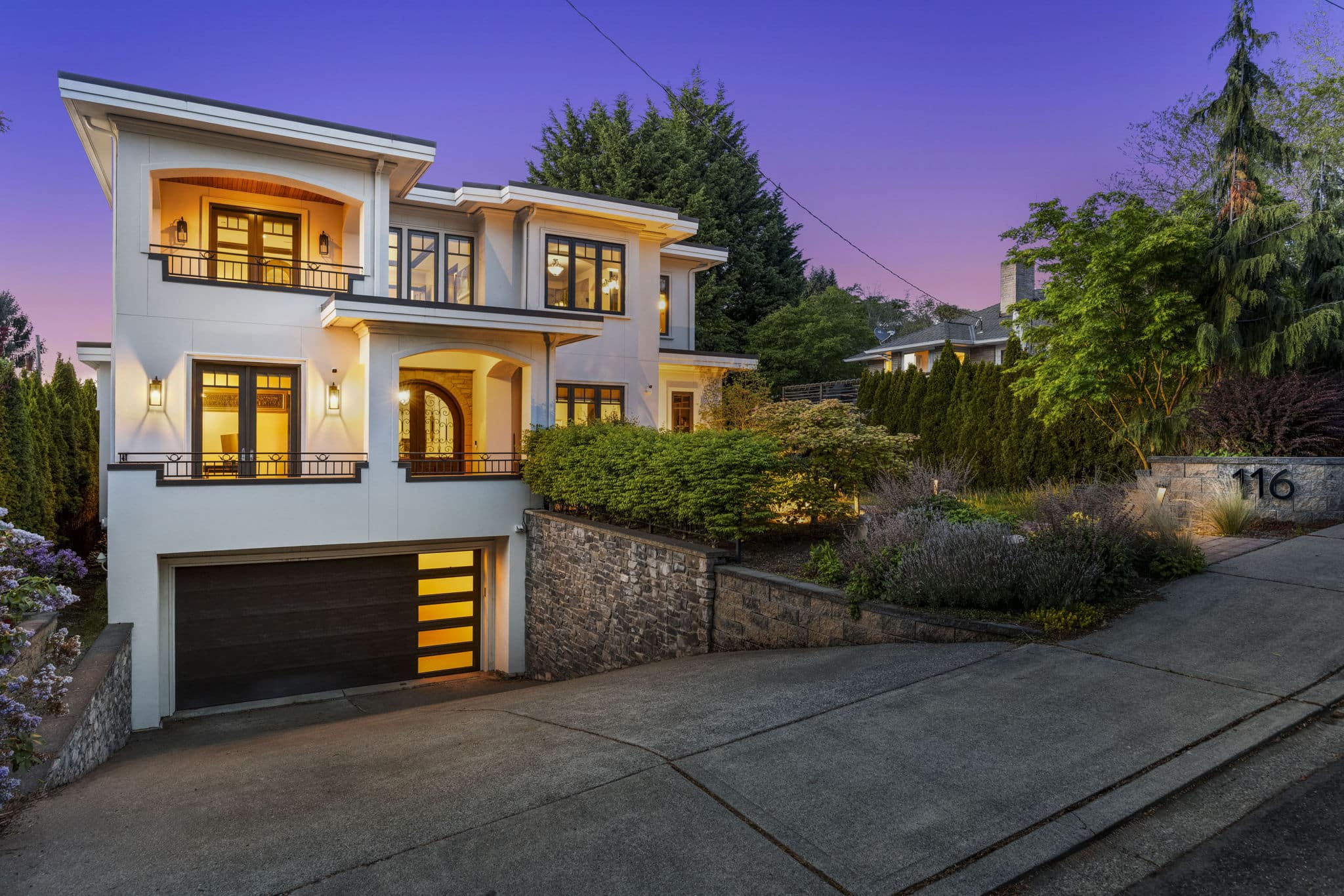 Mediterranean-style Puget Sound home exterior at twilight