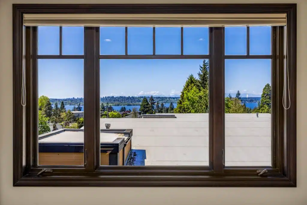 Captivating view of Lake Washington from the Primary Suite's view-swept picture window with rich wood framing.