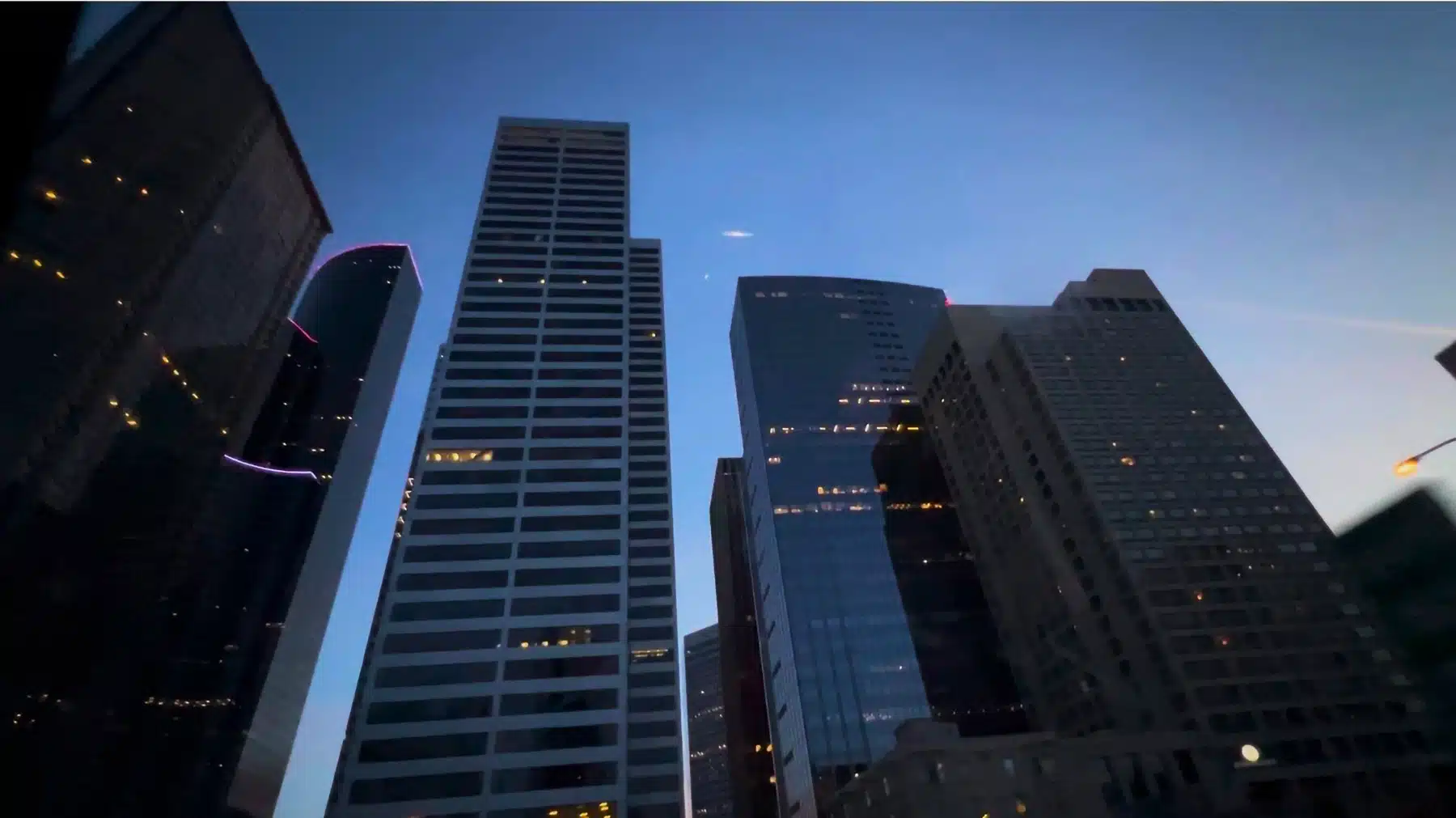 Seattle Neighborhood & Real Estate Guide (2026) 2 Downtown Seattle high-rise office towers viewed from street level against a deep blue twilight sky, windows glowing in the financial district
